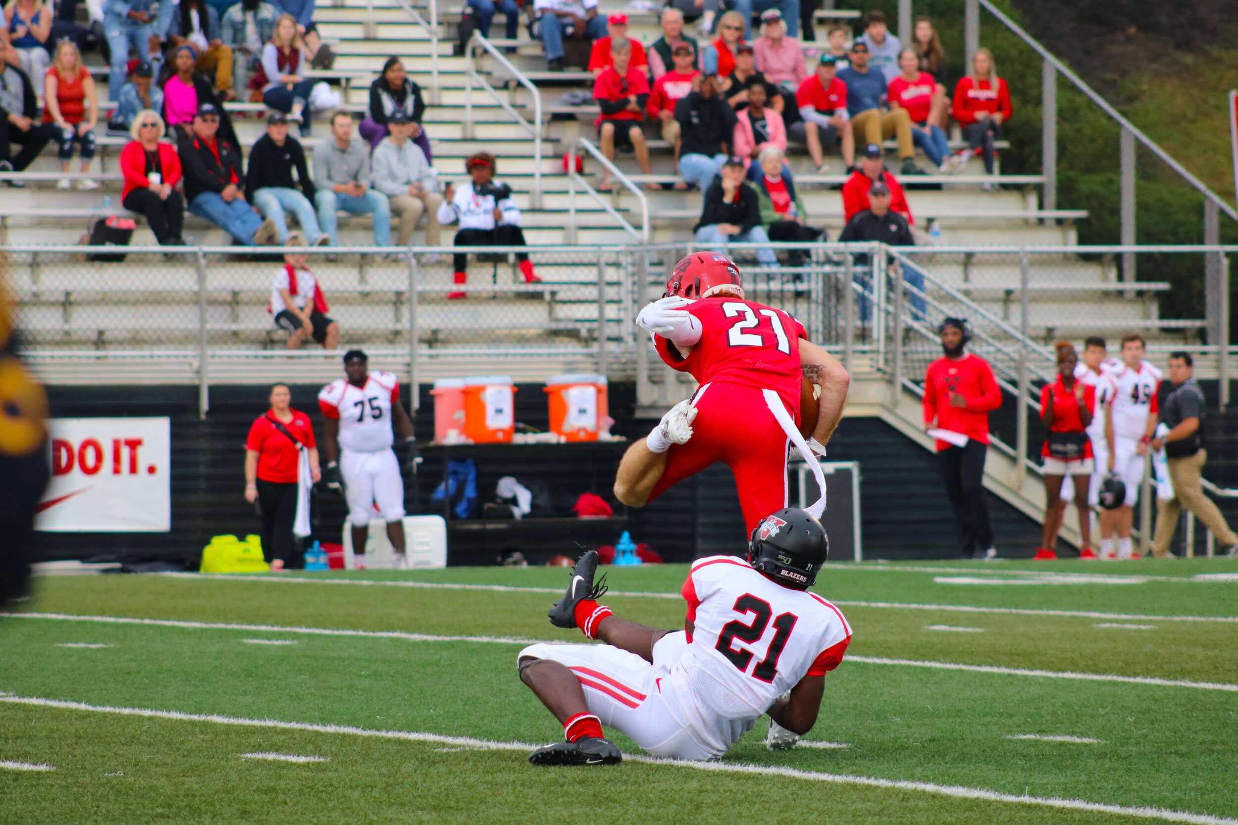 Junior Matthew Martin (21) jumps free from the Blazers grasp and runs the ball down the field.