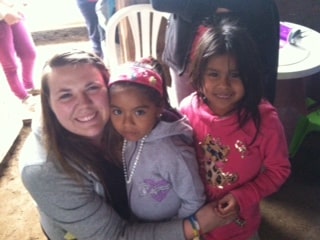  Halie poses with some little girls from a village she worked in. 