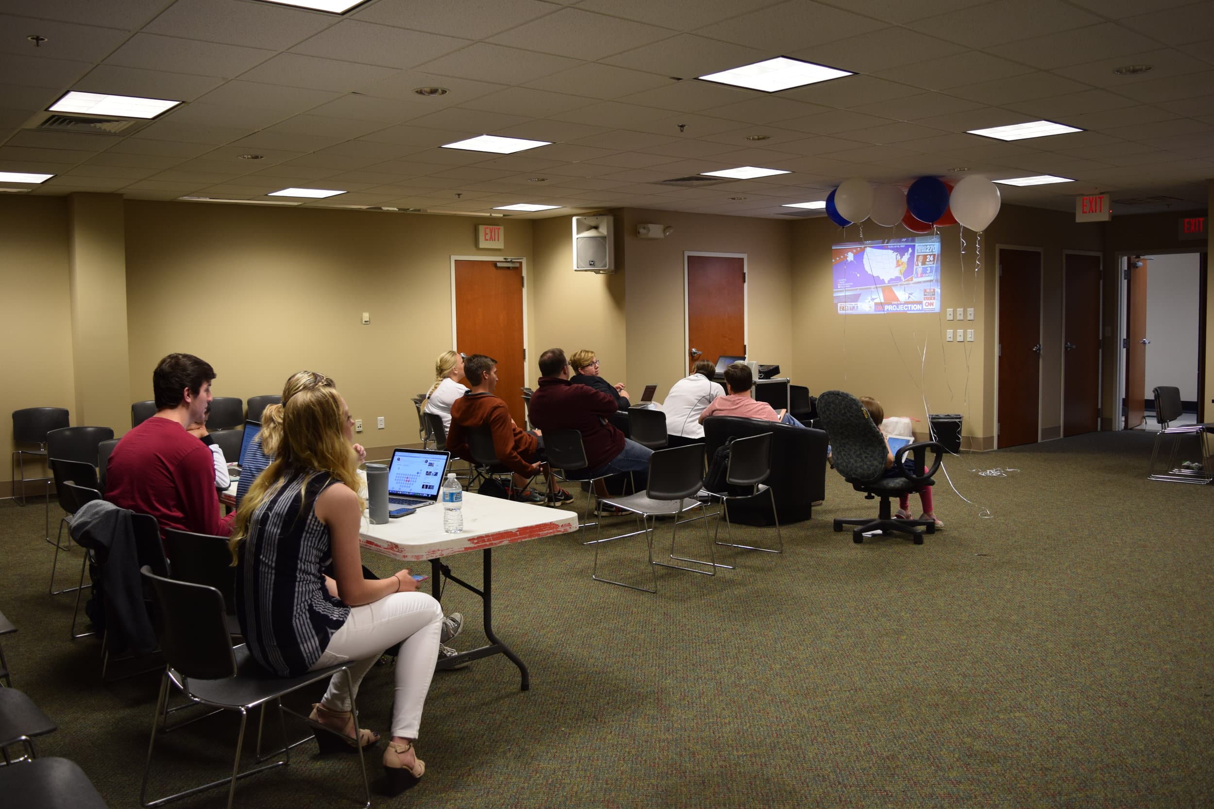 Students, faculty and staff view the election coverage in the Joyful Sound conference room.