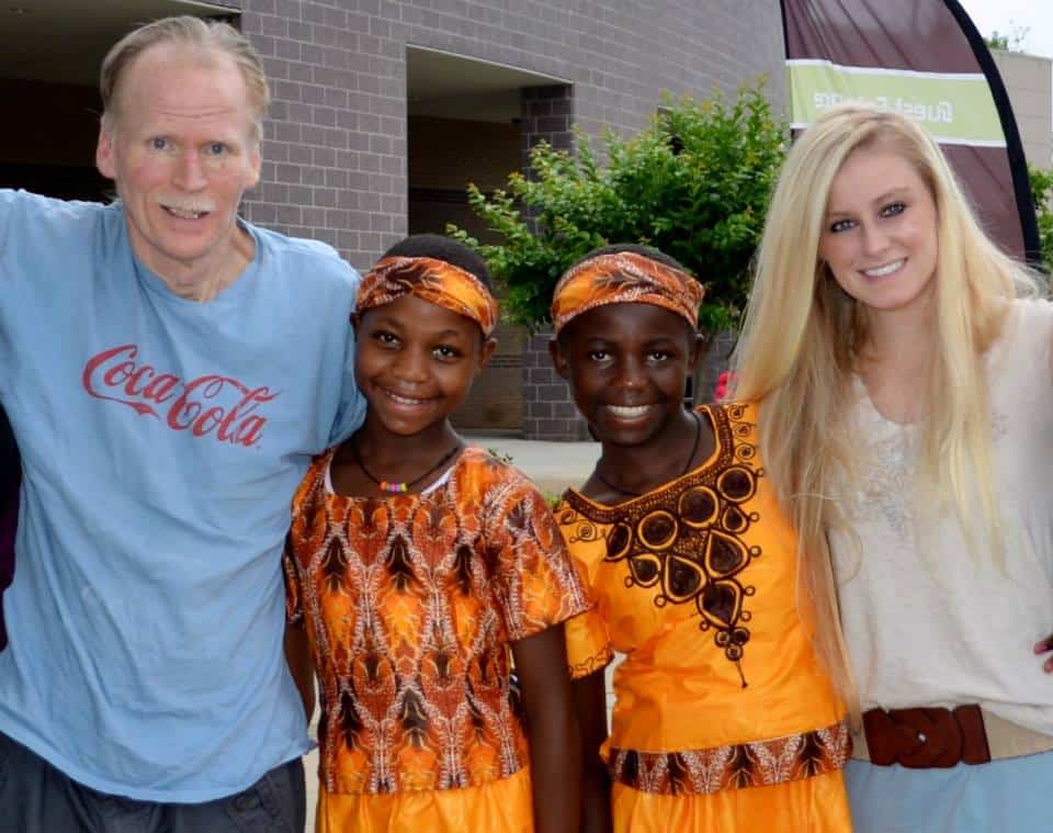 Photo courtesy of Katie JonesKatie Jones and her father, Ken, stand with two of the young girls they ministered to while on the mission field.