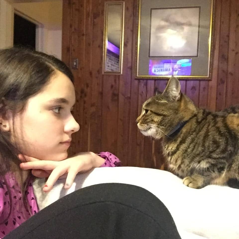 Charlotte Watson, seventh grade, with her cat Lucky. Lucky, now about eight years old, was hit by a car as a kitten, and now spends most of her time sleeping and staring at walls.