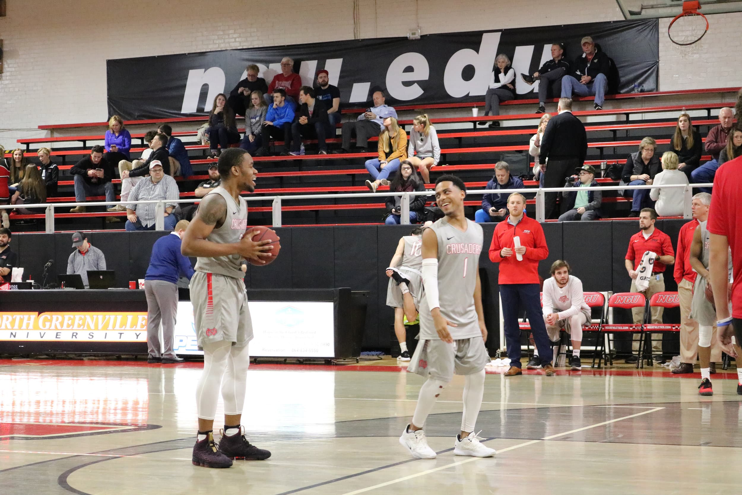 Sophomore Daniko Jackson (1) and Tate (3) talk while they warm up during half time.