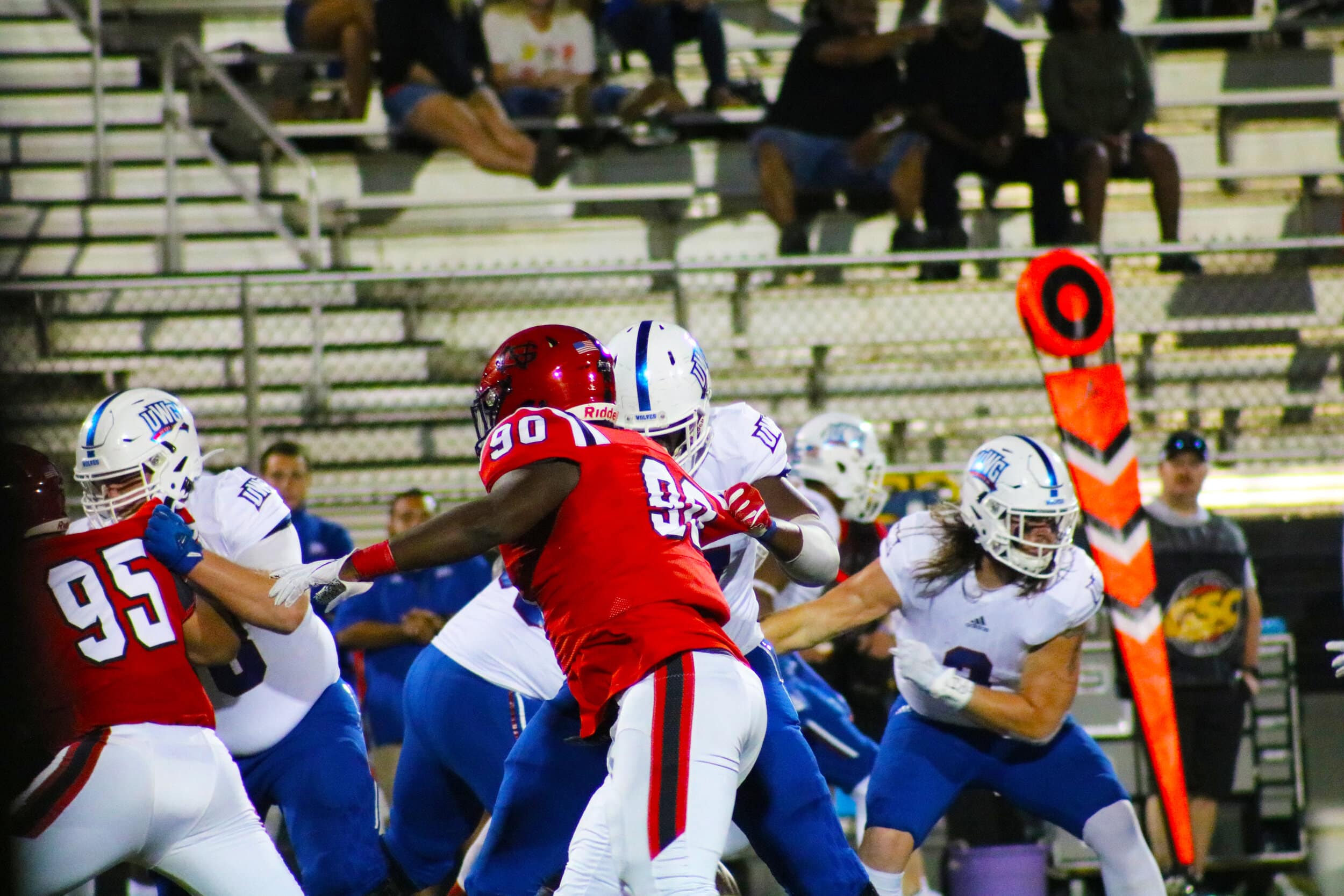 Senior Zeke Stringer (90) and freshman Jacob Stone (95) hold the line for the Crusaders during a play against the Wolves.