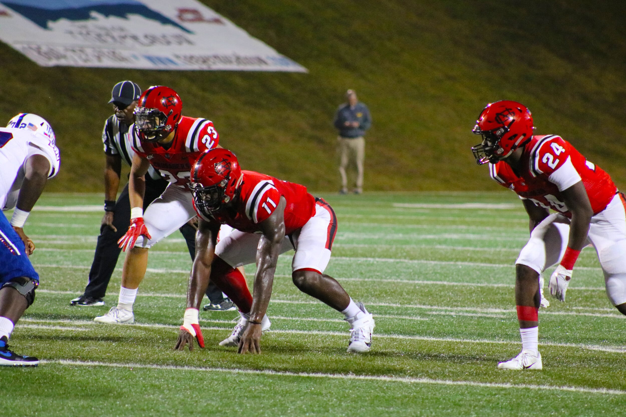 Junior Caleb Bynum, 23, senior Chauncy Haney, 11, and freshman Micah Bryant, 24, line up while waiting for the wolves to snap the ball.