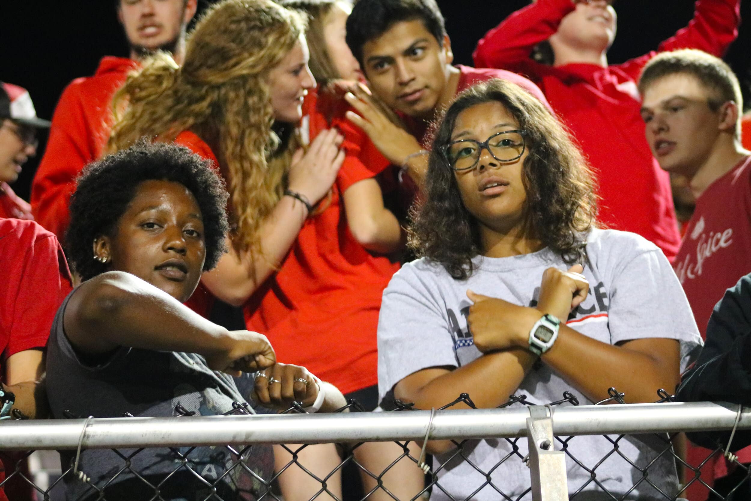 Sophomore Kira Hearns and sophomore Marley Quigley-Jones dance in the student section while the DJ plays music after a play.