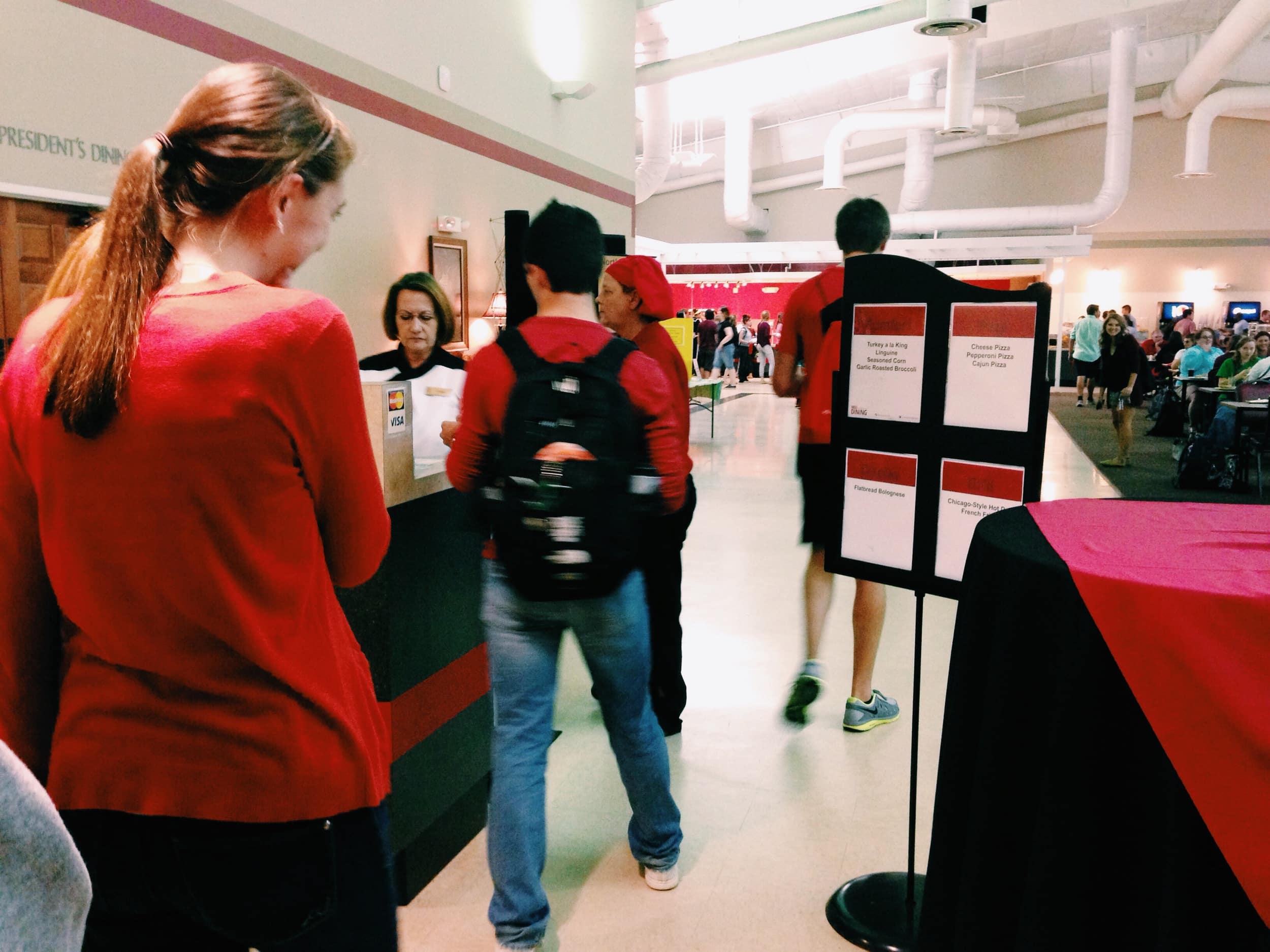  Courtney reads the menu items for the dining hall before getting her food. 