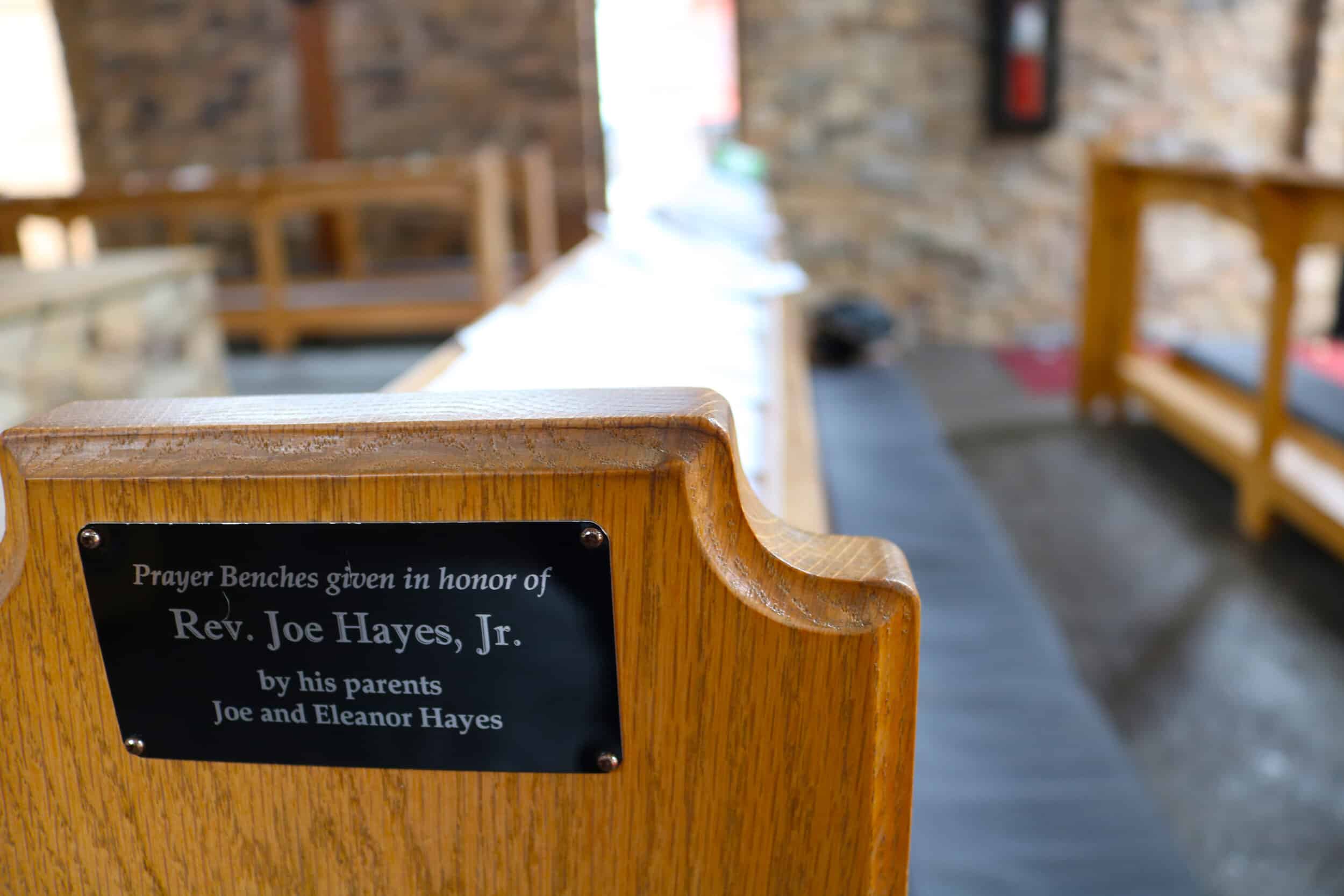 Prayer benches, which were given in honor of Reverend Joe Hayes, Jr. by his parents Joe and Eleanor Hayes. The benches are where students can come and sit, kneel, or even lay down and pray, or even just sit there and think.