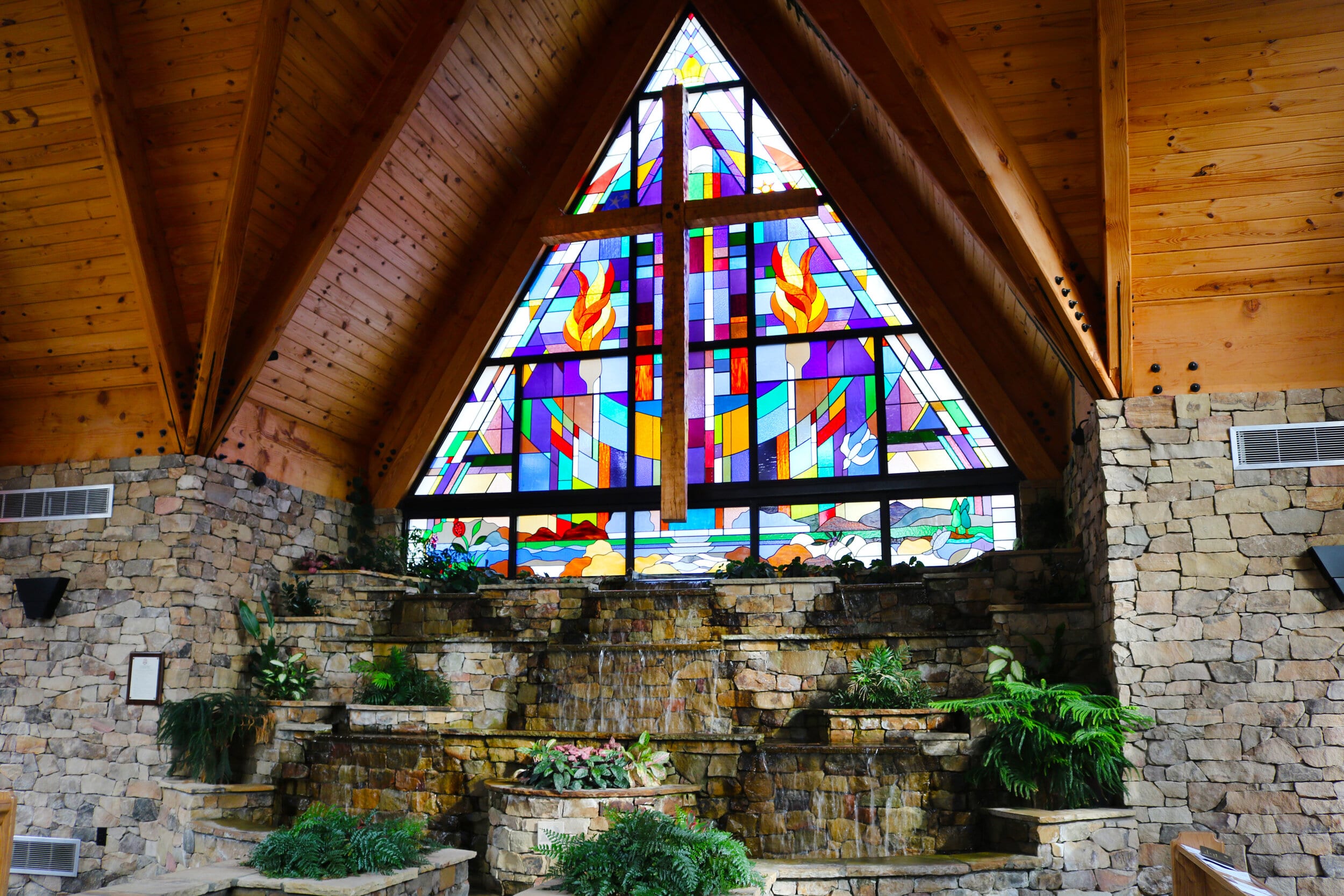 The stained glass window and the rock wall waterfall from a different point of view.