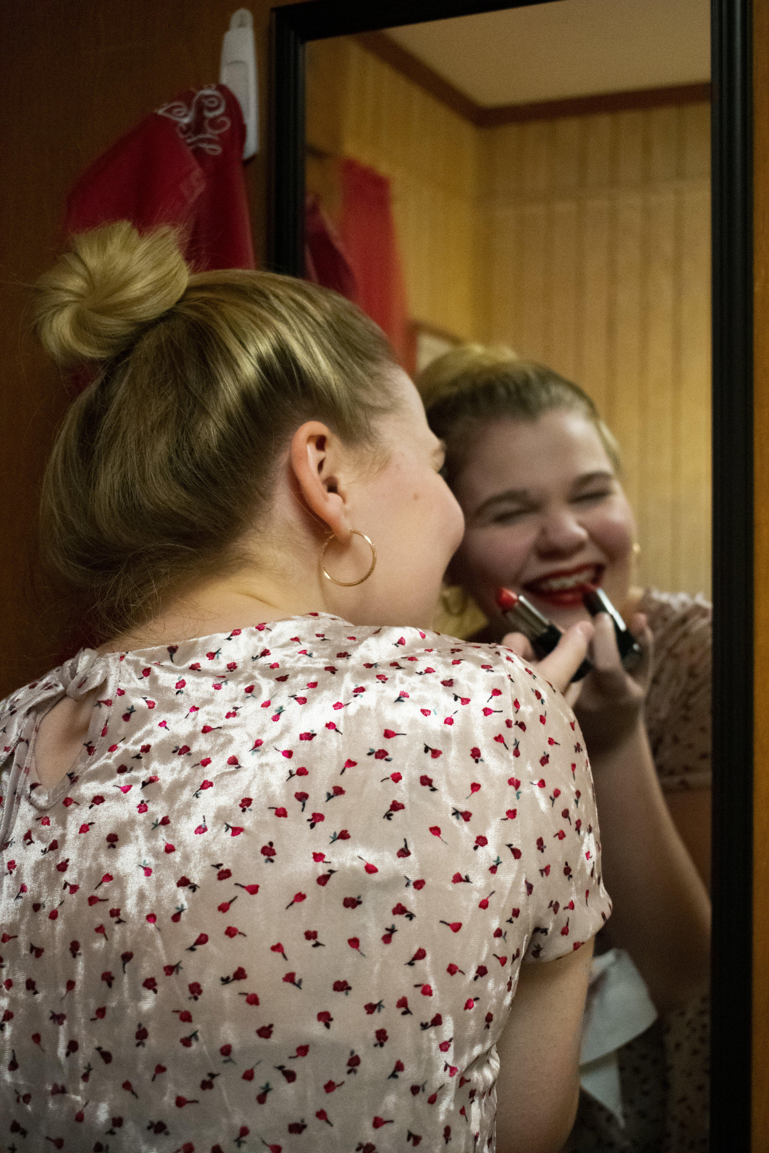 Freshman Emily Hansen wants to feel festive so she carefully applies red lipstick.