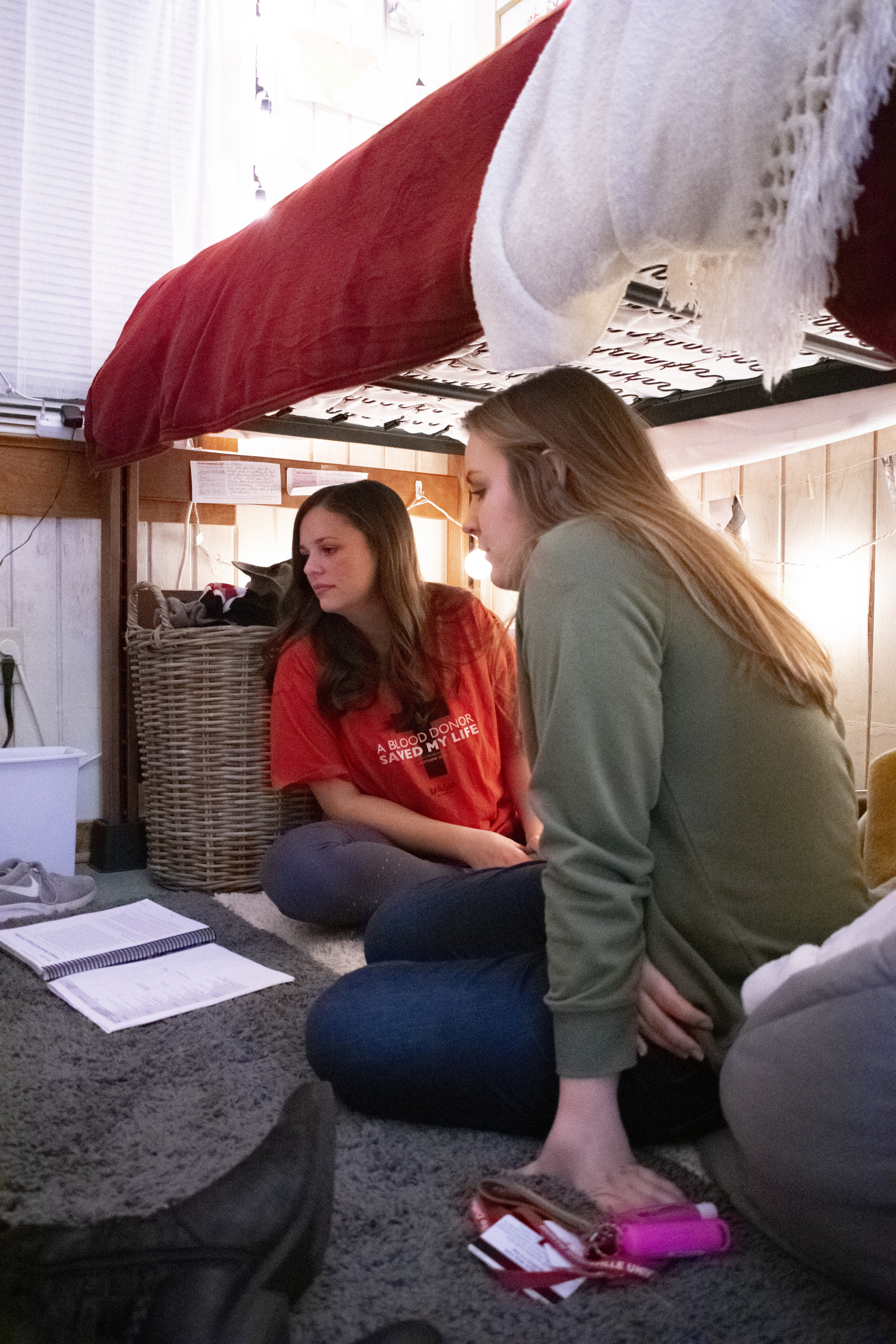 Freshman Johnnah Hobbs and Lanae McClure are shown something on their friends phone.